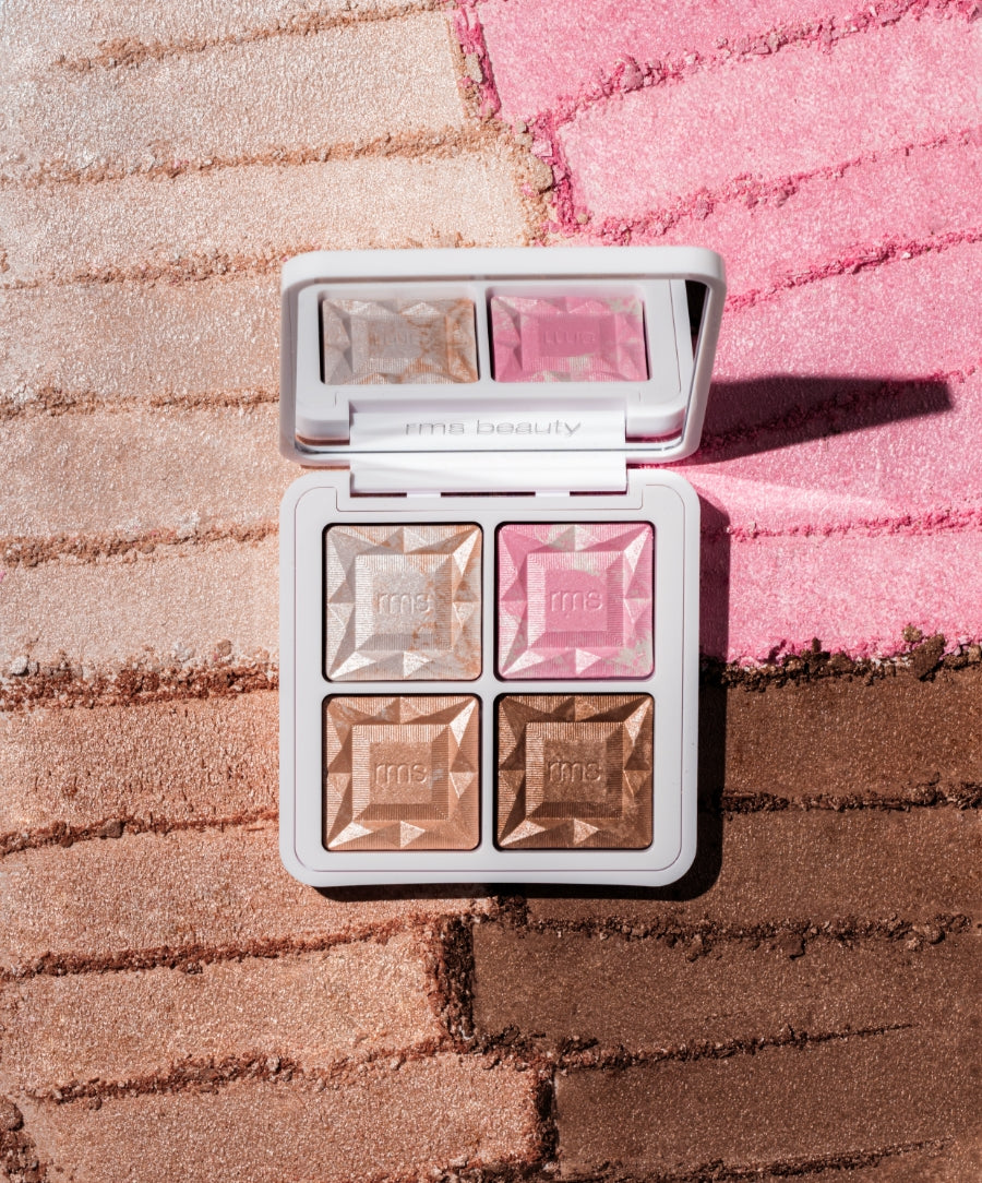 ReDimension Daily Glow Palette open to reveal four textured shimmer shades in neutral and pink tones with a mirror, displayed on matching swatches in soft lighting.