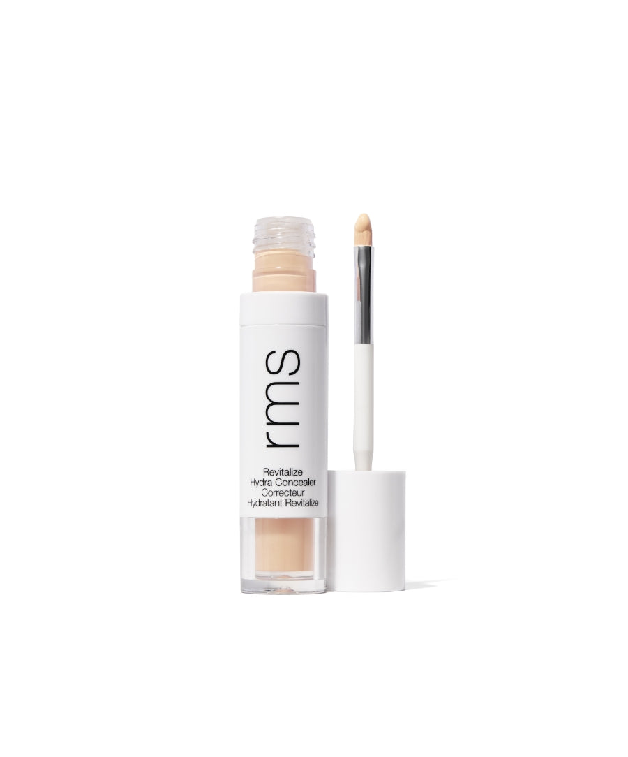 Open tube of Revitalize Hydra Concealer with beige liquid concealer and attached applicator wand, featuring clean white packaging and minimalist design.