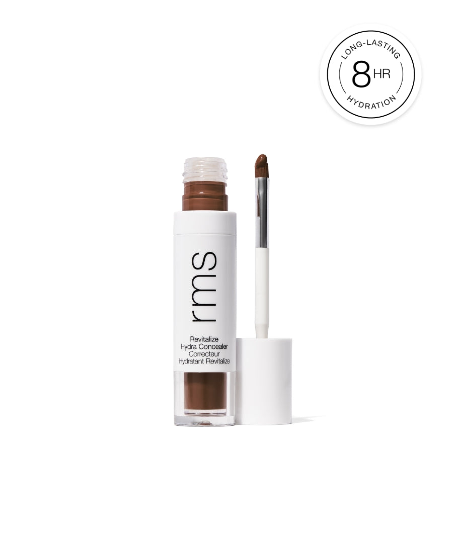 Open tube of Revitalize Hydra Concealer with visible brown cream and applicator brush, highlighting long-lasting hydration up to 8 hours, clean beauty and natural ingredients.