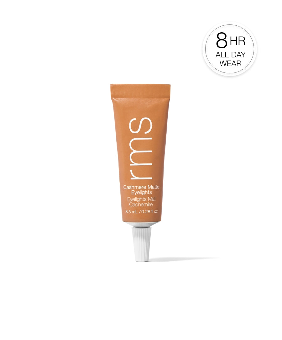 Tube of RMS Beauty Cashmere Matte Eyelights makeup in a warm dusty trail shade, highlighting 8-hour all day wear with clean beauty, natural ingredients, and cruelty free makeup benefits.