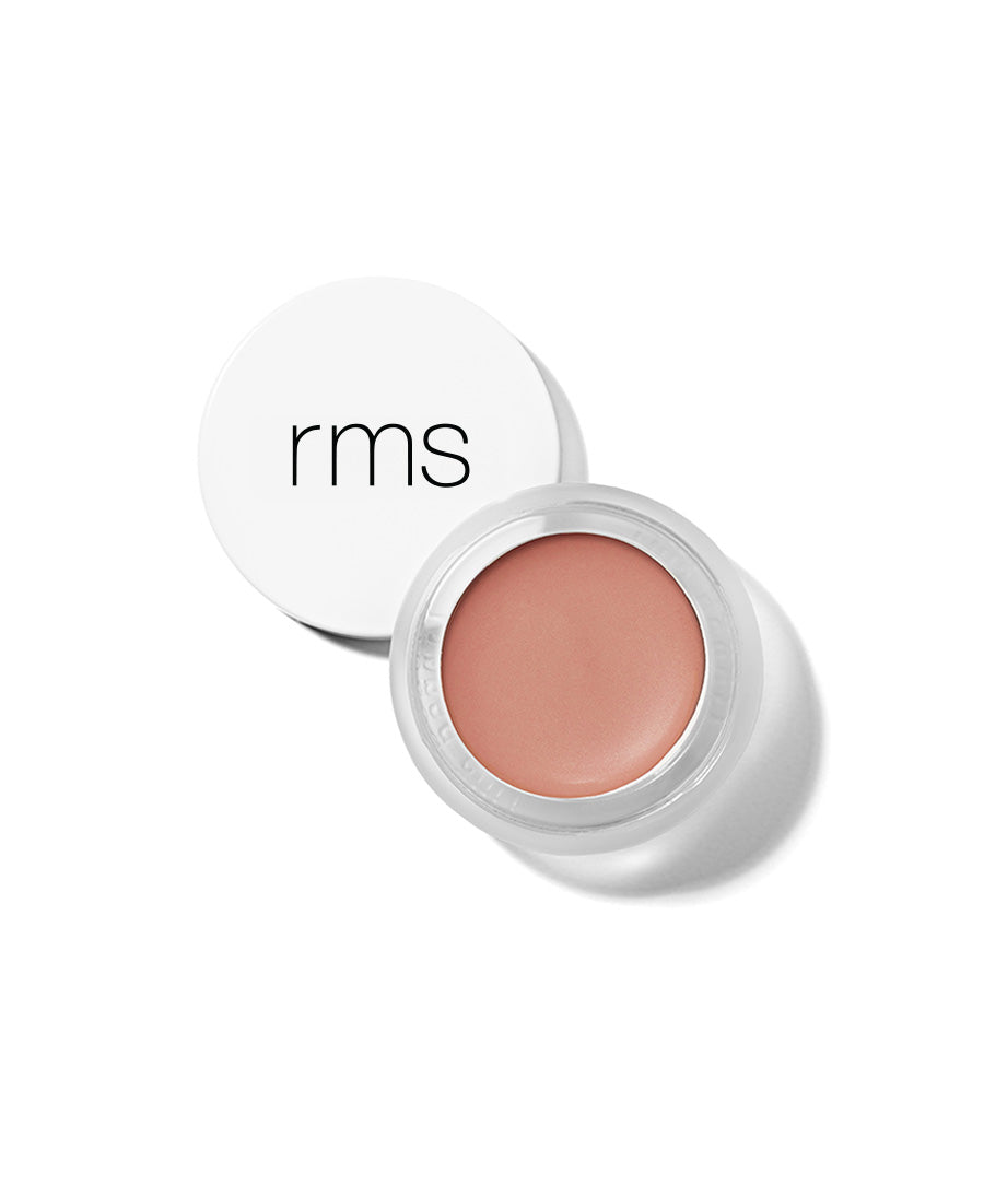 Open jar of Lip2Cheek cream makeup in a natural, muted peach shade with a white lid featuring "rms" branding, highlighting clean beauty and skincare infused makeup.