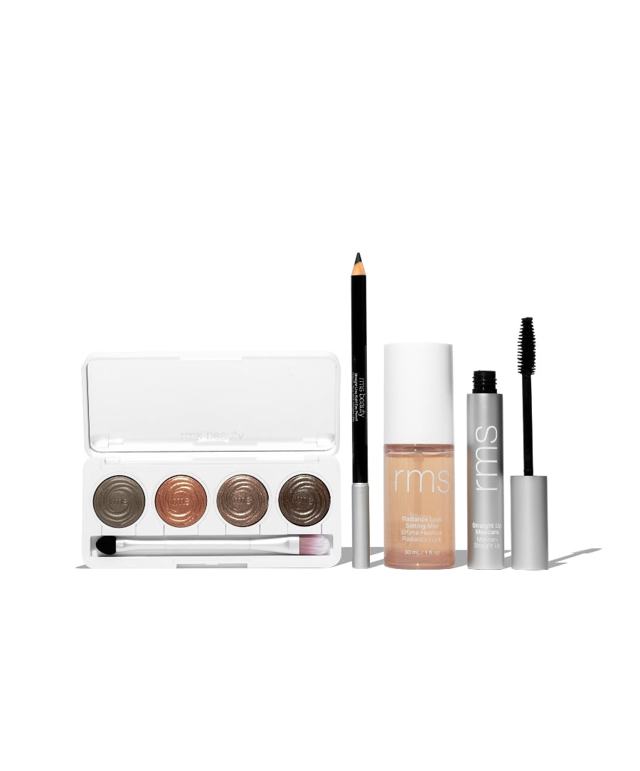 The Signature Artistry Set featuring a neutral eyeshadow palette, black eyeliner pencil, natural liquid foundation, and mascara, showcasing clean beauty with natural ingredients.