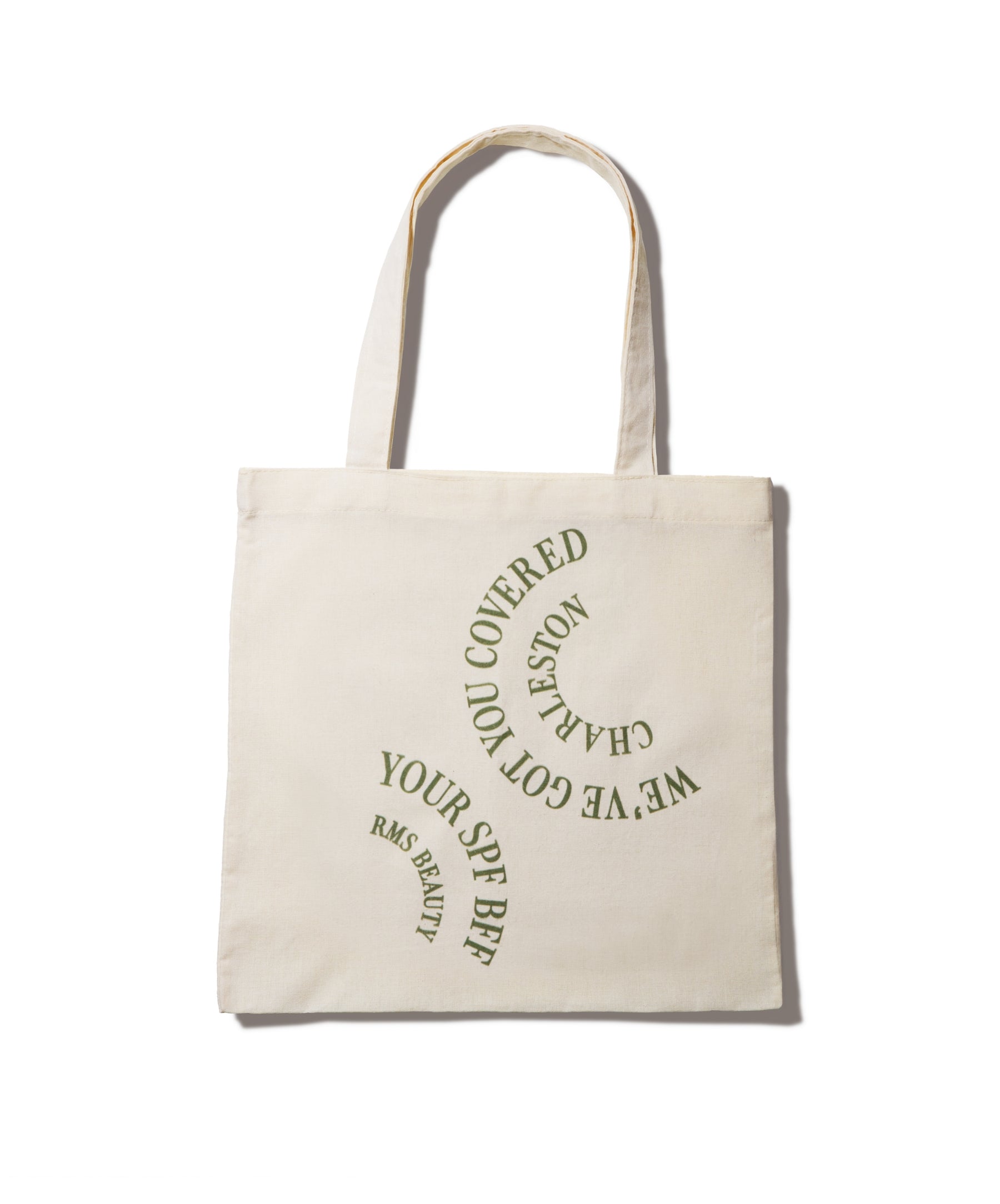We've Got You Covered Charleston Tote in natural fabric with green curved text reading "We've Got You Covered Charleston" and "Your SPF BFF RMS Beauty," eco-friendly reusable bag for clean beauty essentials.
