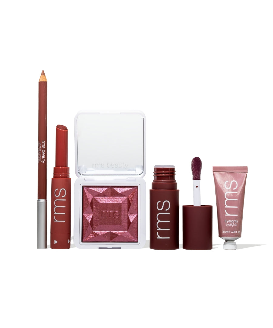 Color Capsule: The Wine Edit featuring a range of RMS Beauty makeup products in deep wine and berry tones including lip liner, lipstick, eyeshadow, lip gloss, and eye primer with clean, cruelty-free ingredients.