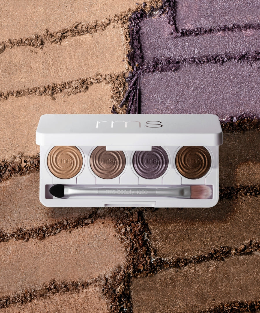 ReDimension Hydra Eyes Quartet eyeshadow palette featuring four neutral and purple shades with a dual-ended brush, displayed on a textured background emphasizing natural and clean beauty.