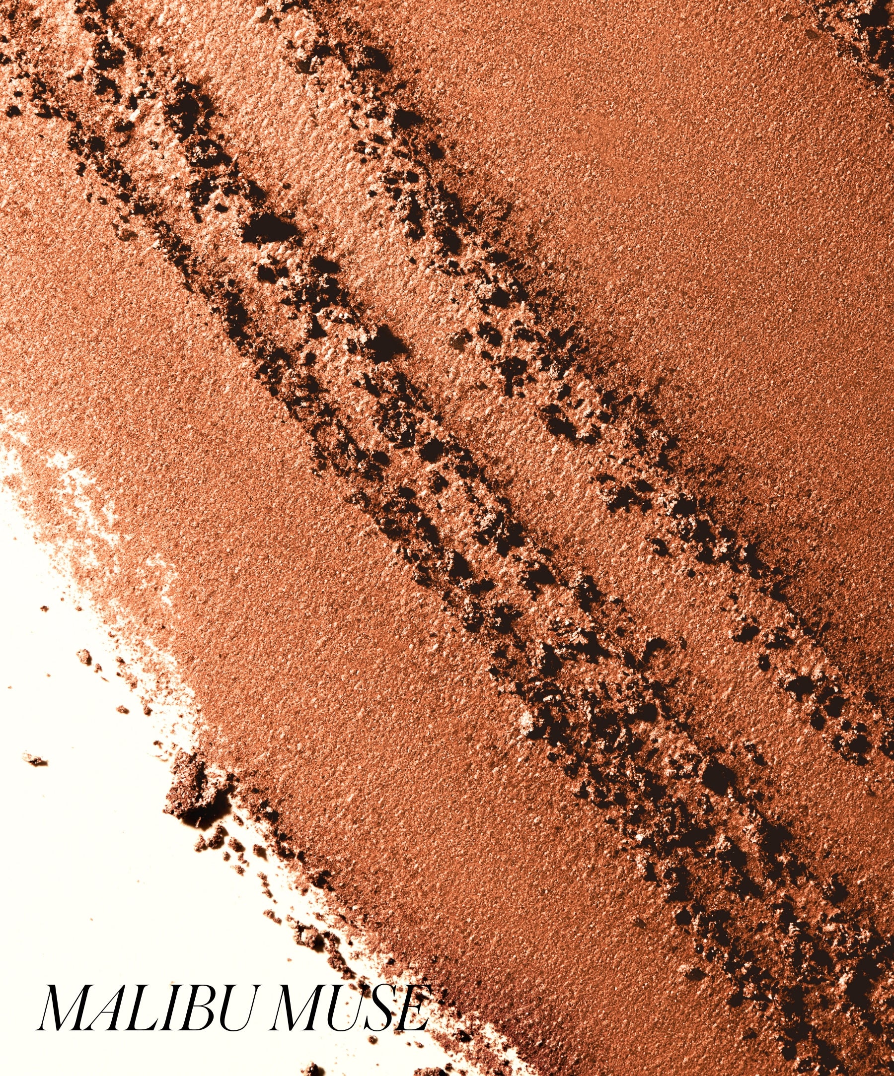 Shimmering crushed powder in warm brown shades showcasing the texture and color intensity of ReDimension Hydra Bronzer, emphasizing natural glow and clean beauty.