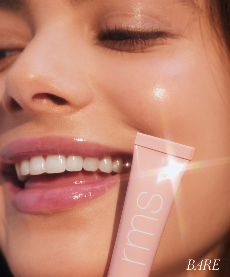 Close-up of a smiling face with glossy lips wearing Liplights Cream Lip Gloss, highlighting natural, radiant skin and a soft pink gloss finish.