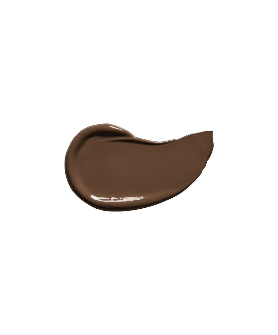 Smooth swatch of rich brown creamy makeup product showcasing the shade of Revitalize Hydra Concealer with a natural, skincare-infused formula.