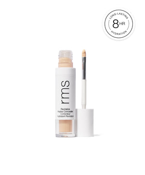 Open tube of Revitalize Hydra Concealer with applicator brush showing light beige creamy makeup, highlighting long-lasting hydration for 8 hours.