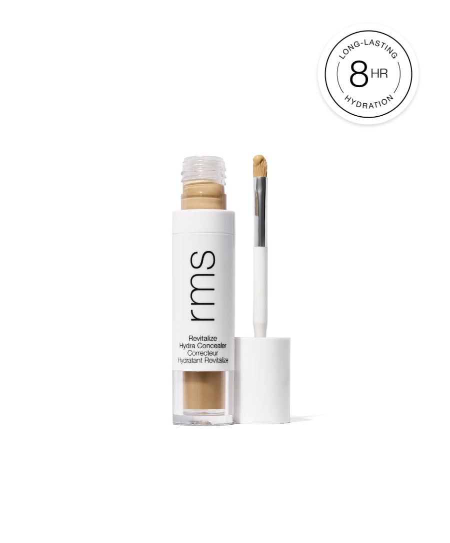 Revitalize Hydra Concealer by RMS Beauty in a clear and white tube with an applicator wand, shown with a creamy beige shade and a label highlighting long-lasting hydration up to 8 hours.