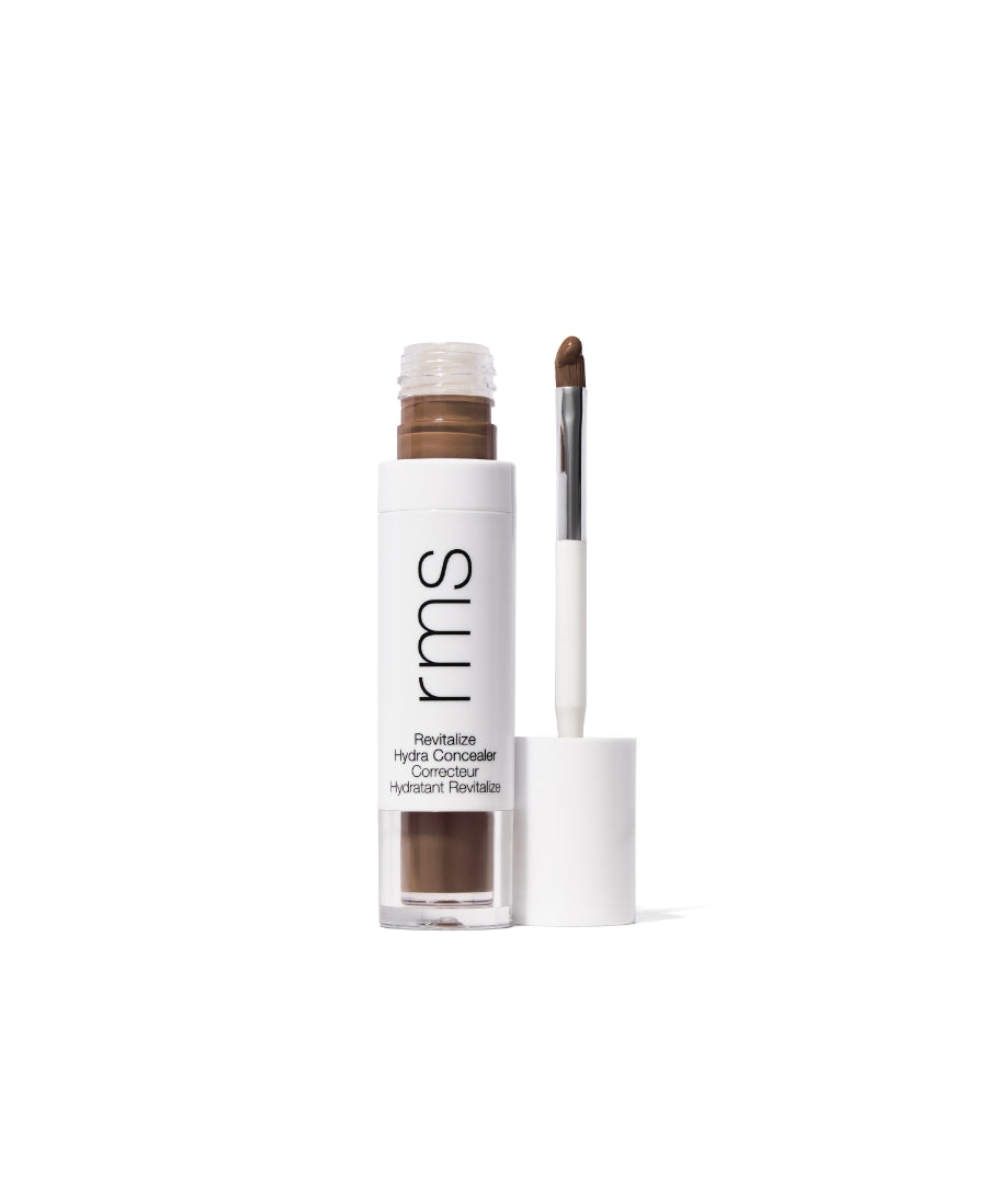Open tube of Revitalize Hydra Concealer with a doe-foot applicator showing medium brown shade, featuring clean beauty and sustainable packaging.