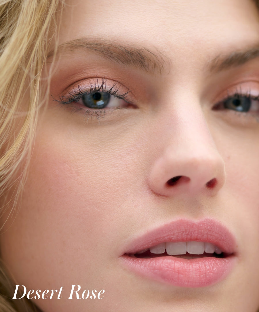 Close-up of a woman's face showcasing soft, natural eye makeup and lips in warm rose tones, highlighting the subtle, smooth finish of Cashmere Matte Eyelights.