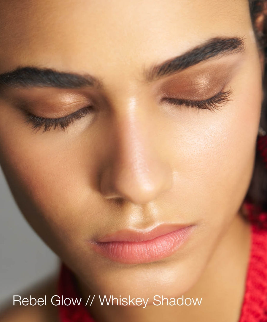 Close-up of a woman with eyes closed wearing warm brown eyeshadow and natural makeup showcasing ReDimension Hydra Eyes Quartet in Rebel Glow and Whiskey Shadow for a radiant look.