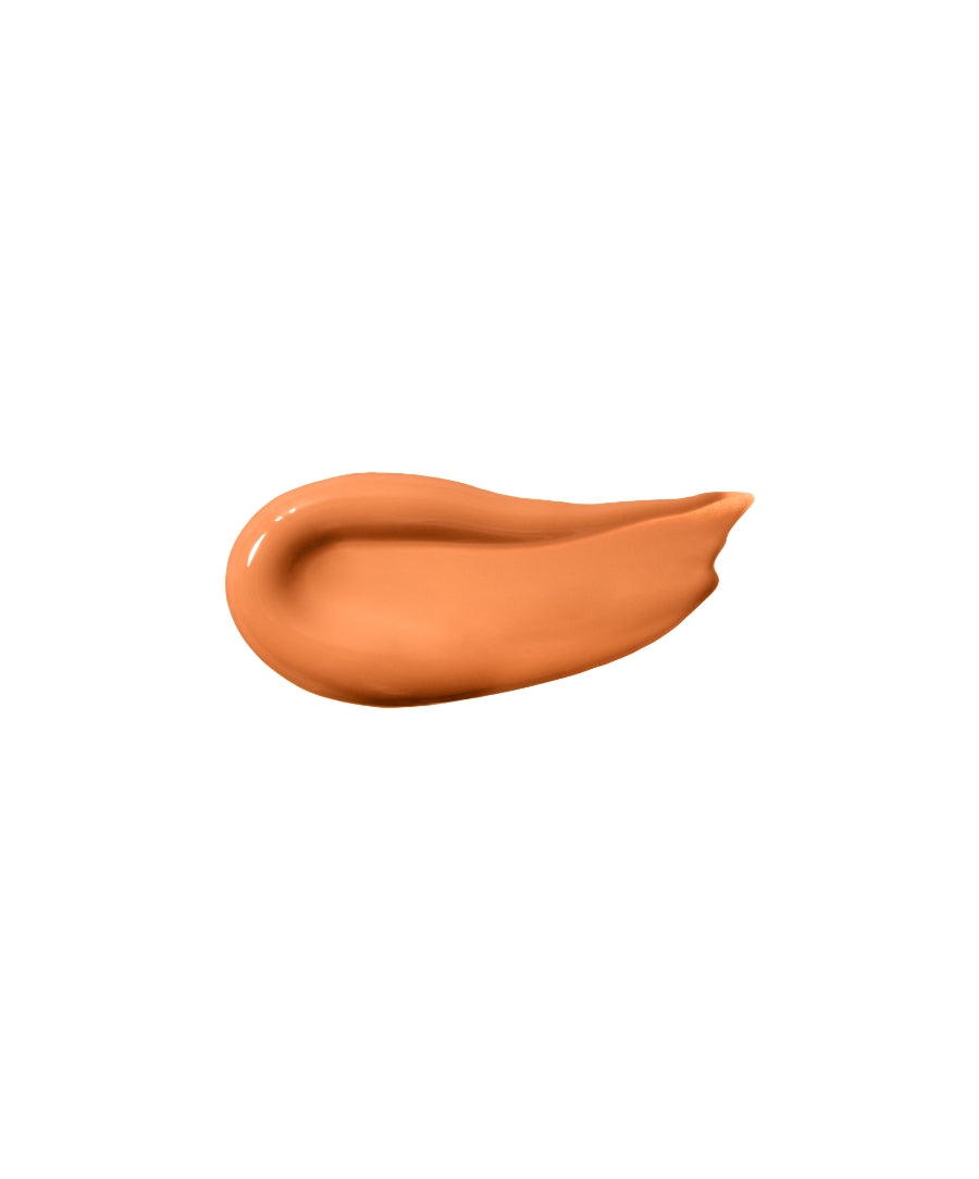 Smooth swatch of warm peach-colored cosmetic cream showcasing ReFresh Eye Brightener Broad Spectrum SPF 30 + Correcting Tint, highlighting its natural ingredients and clean beauty appeal.