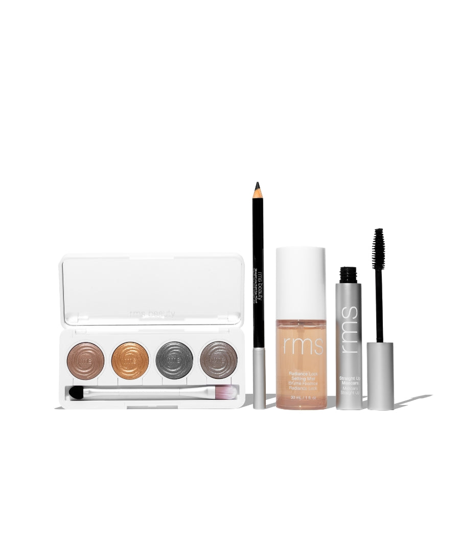 The Signature Artistry Set featuring a neutral eyeshadow palette, black eyeliner pencil, liquid foundation, and mascara with clean beauty ingredients in recyclable packaging.