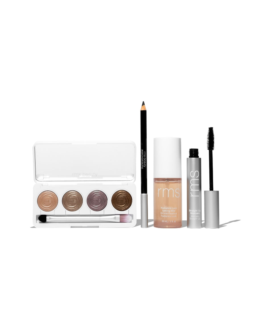 The Signature Artistry Set featuring a palette with four neutral cream eyeshadows, an eyeliner pencil, a foundation bottle, and a mascara tube, showcasing clean, cruelty free makeup essentials.