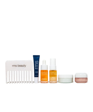 The Travel Skincare Set featuring RMS Beauty products includes a comb, lip balm, two facial serums, and two cream jars in clean beauty formulations with natural, organic ingredients.