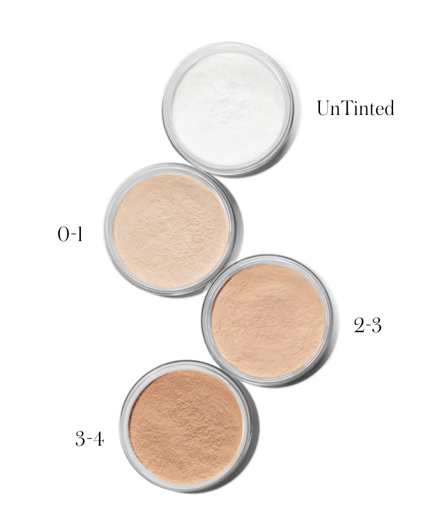 Four open containers of translucent and tinted powders in varying shades from light to medium beige, displaying options for the Tinted UnPowder makeup product.