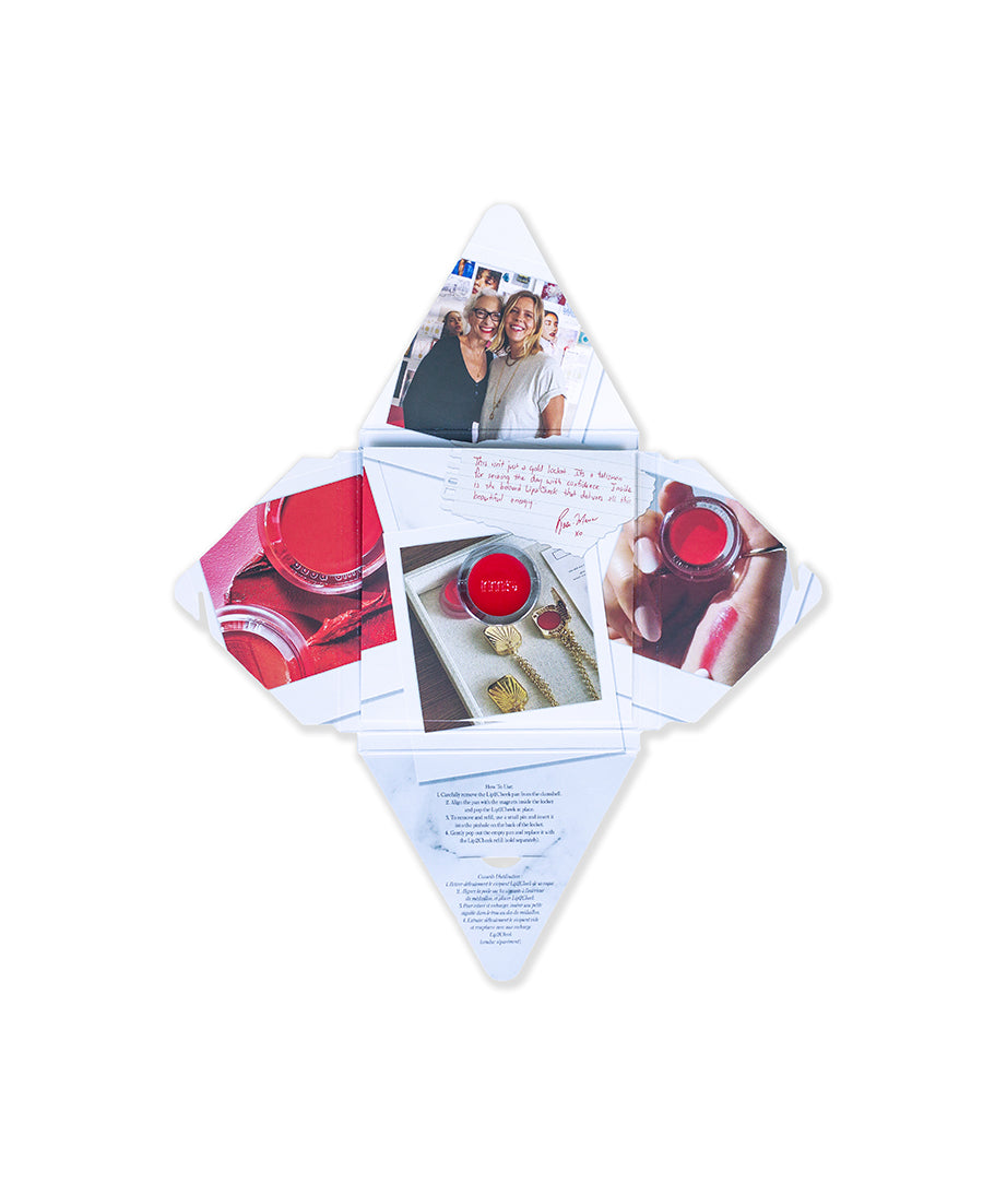 An open square-shaped fold-out featuring photos of two smiling women, close-ups of red lip product containers, a handwritten note, and the HART x RMS: Lip2Cheek Locket with gold chains, highlighting clean beauty and sustainable packaging.