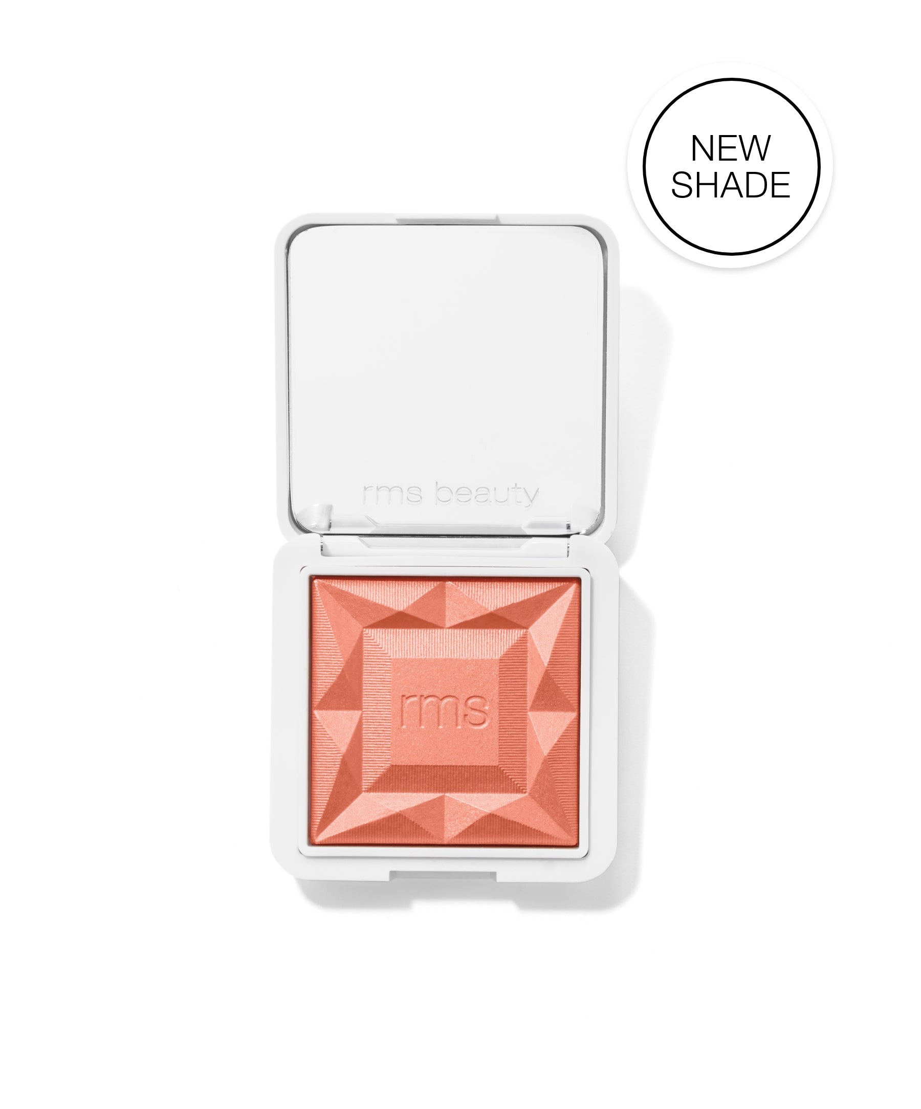 ReDimension Hydra Powder Blush in a new coral shade with embossed geometric design in a sleek white compact from RMS Beauty, featuring clean and natural ingredients.