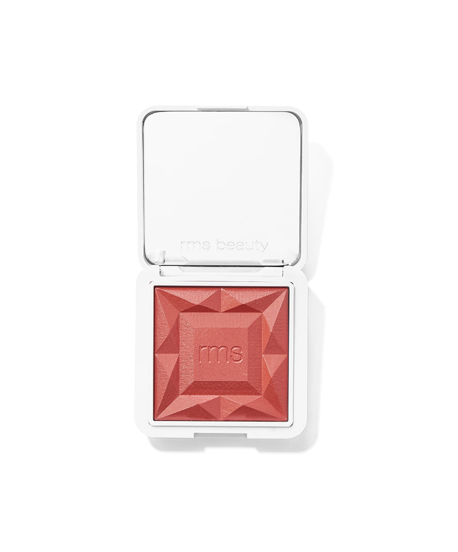 ReDimension Hydra Powder Blush in a vibrant coral shade with a geometric embossed design, cruelty free makeup in sleek white packaging from RMS Beauty.