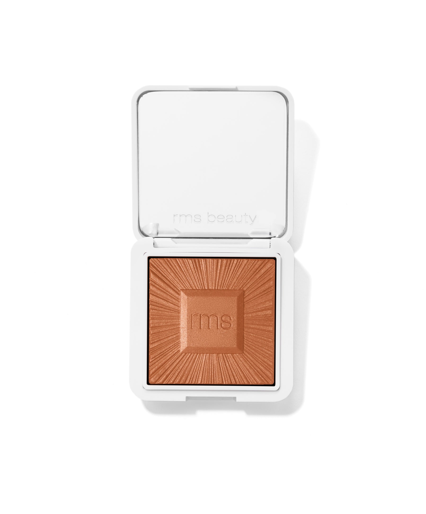 Open compact of ReDimension Hydra Bronzer showing warm bronze powder with embossed rms logo and sunburst pattern in clean white packaging.
