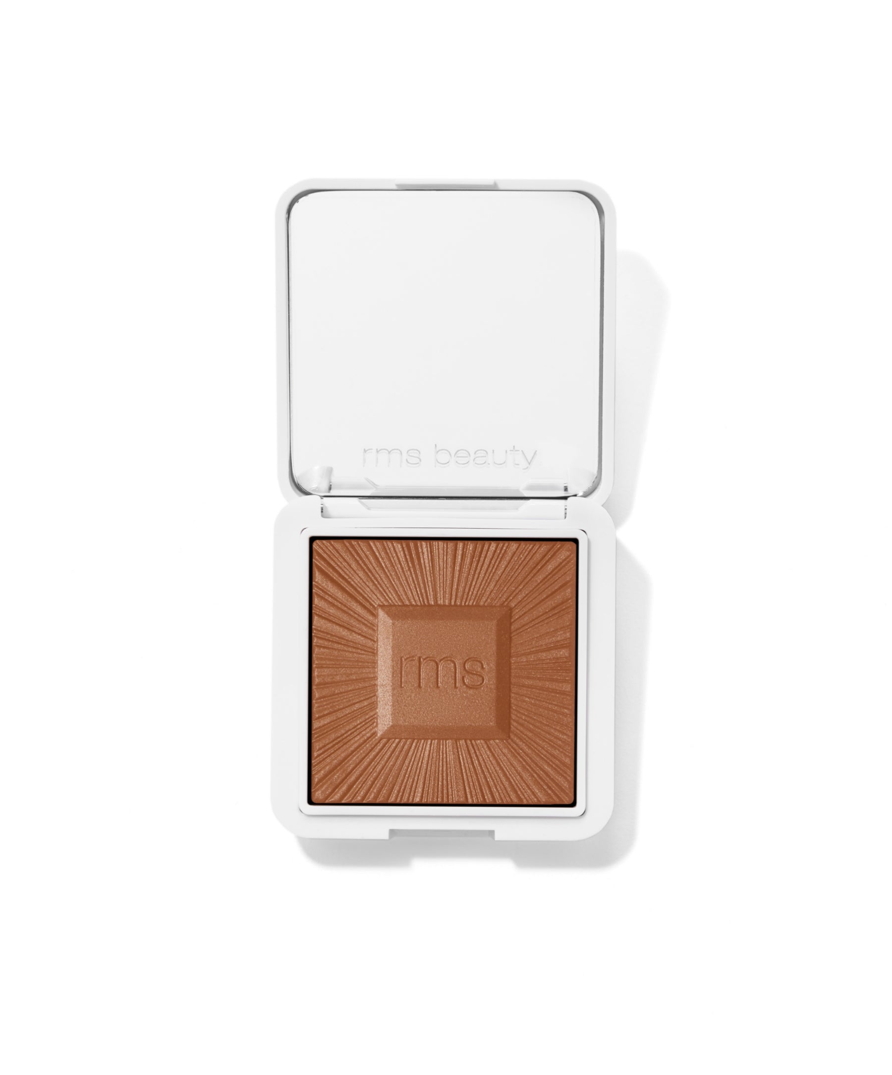 ReDimension Hydra Bronzer in a sleek white compact featuring embossed rays and the rms logo, showcasing a warm, natural bronzing powder with clean beauty and cruelty free makeup qualities.