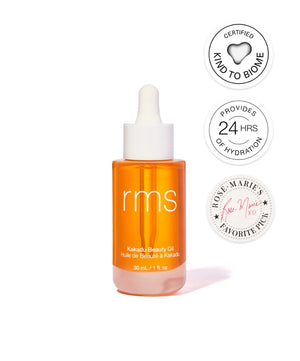 RMS Beauty Kakadu Beauty Oil in a clear orange glass dropper bottle with badges highlighting 24 hours of hydration, kind to biome certification, and a favorite pick endorsement.