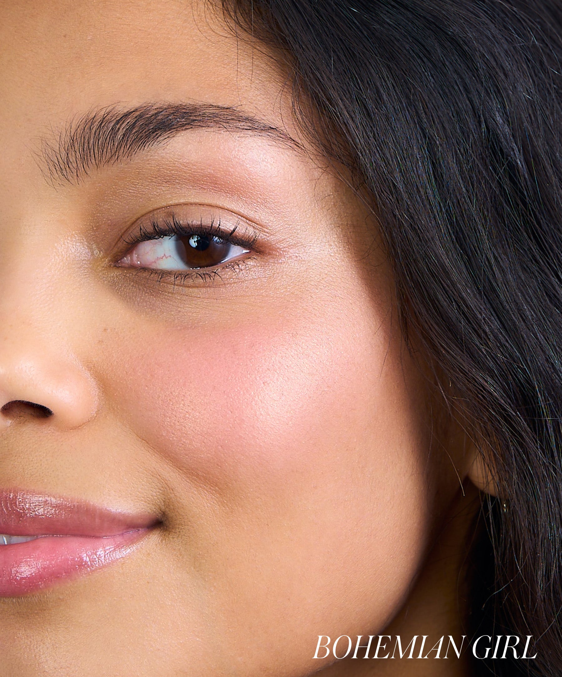 Close-up of a woman’s face showcasing natural makeup with a soft pink blush on her cheek, highlighting the effect of ReDimension Hydra Powder Blush for a radiant, clean beauty look.