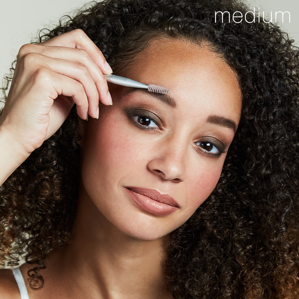 Model using Back2Brow Brush applying Back2Brow Powder in shade Medium on right brow
