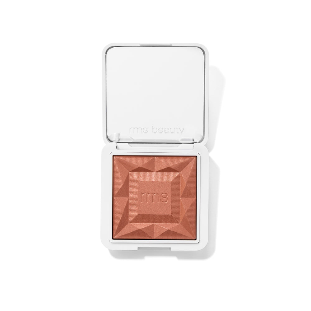 Open compact showing ReDimension Hydra Powder Blush in a warm terracotta shade with a geometric embossed design, featuring clean beauty and natural ingredients.