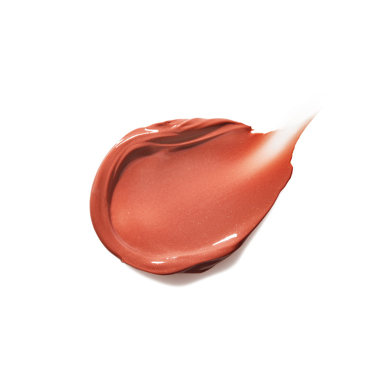 Smooth creamy swatch of Liplights Cream Lip Gloss in a warm, neutral shade with a glossy, radiant finish highlighting clean beauty and natural ingredients.