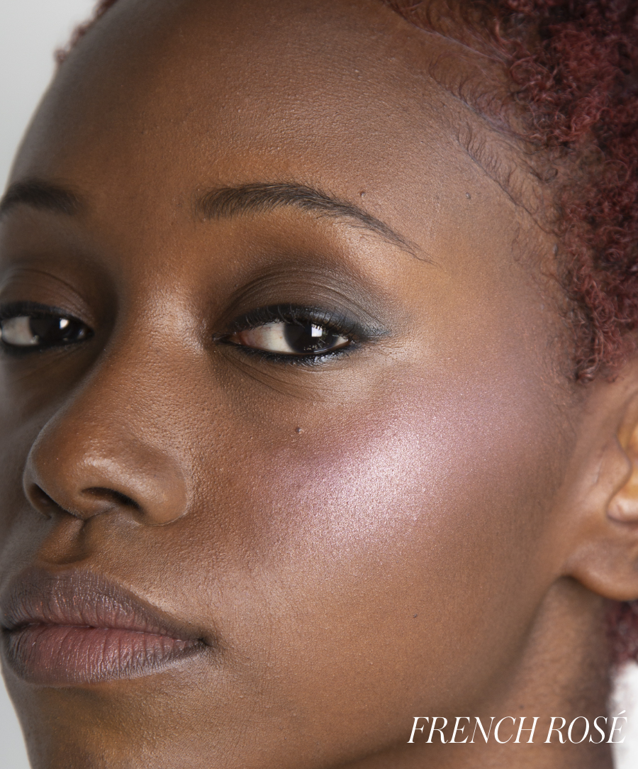 Close-up of a woman with smooth skin wearing ReDimension Hydra Powder Blush in French Rosé, highlighting a natural, glowing finish ideal for clean beauty and sustainable makeup looks.