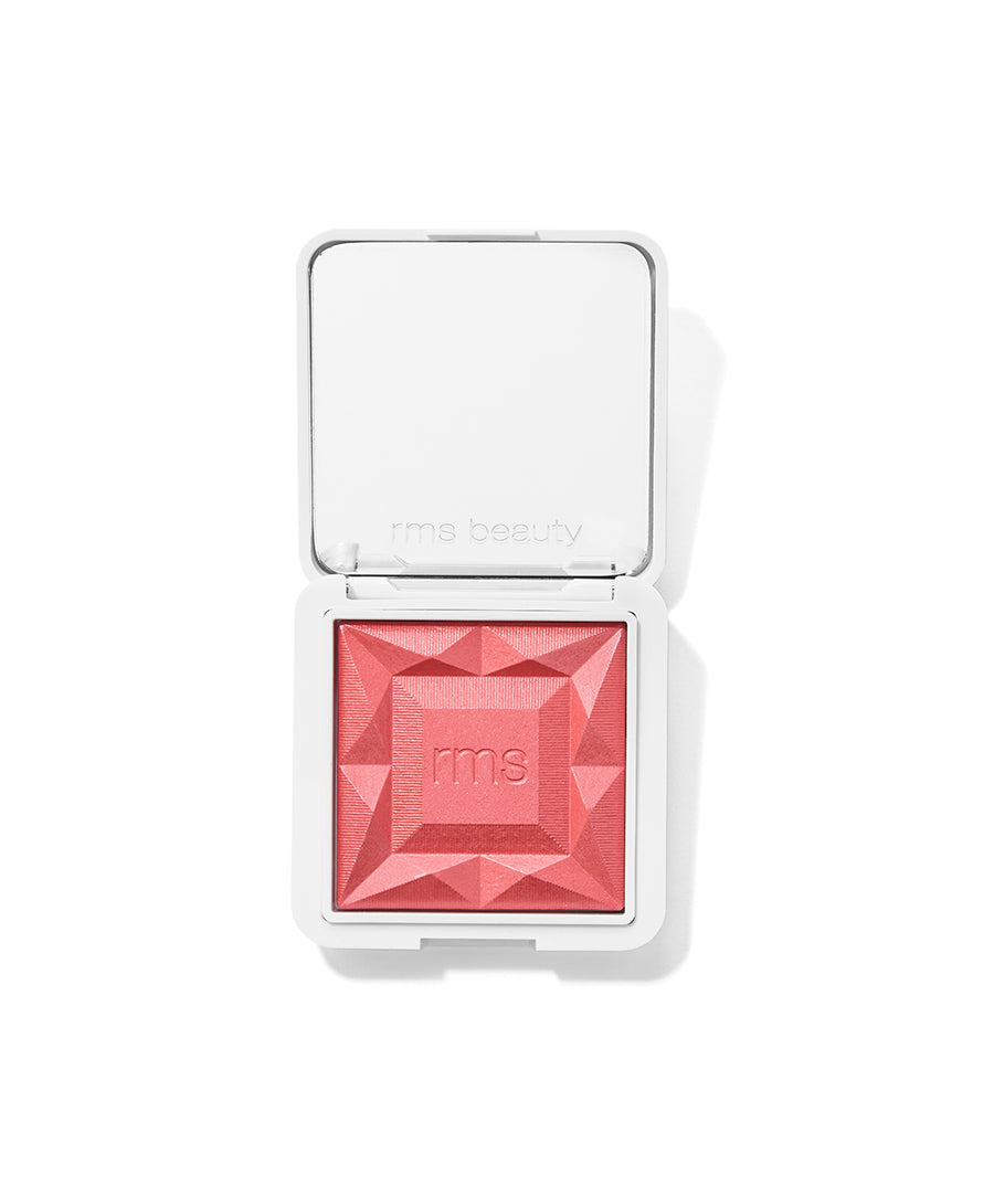 ReDimension Hydra Powder Blush in a coral pink shade with a geometric embossed surface, housed in a sleek white compact by RMS Beauty, featuring clean, cruelty free makeup.