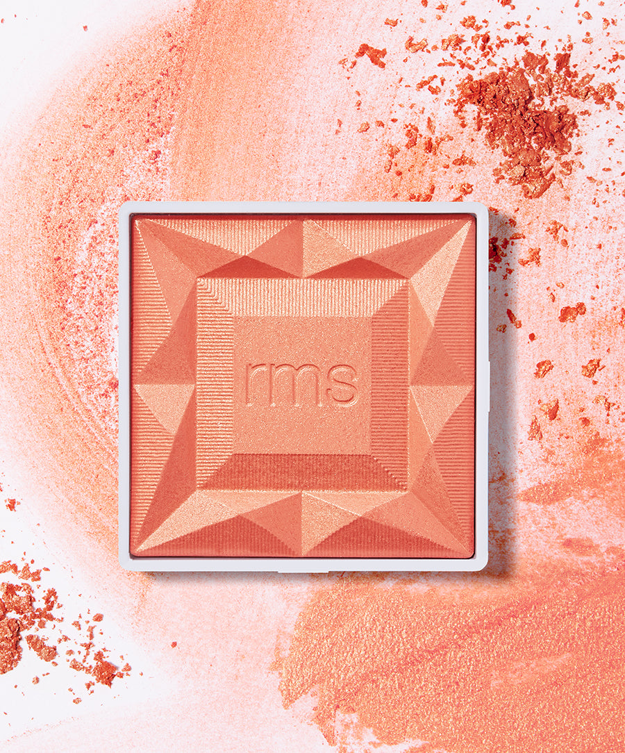ReDimension Hydra Powder Blush in a warm coral shade featuring geometric embossed design, surrounded by soft powder texture highlighting natural ingredients and clean beauty appeal.