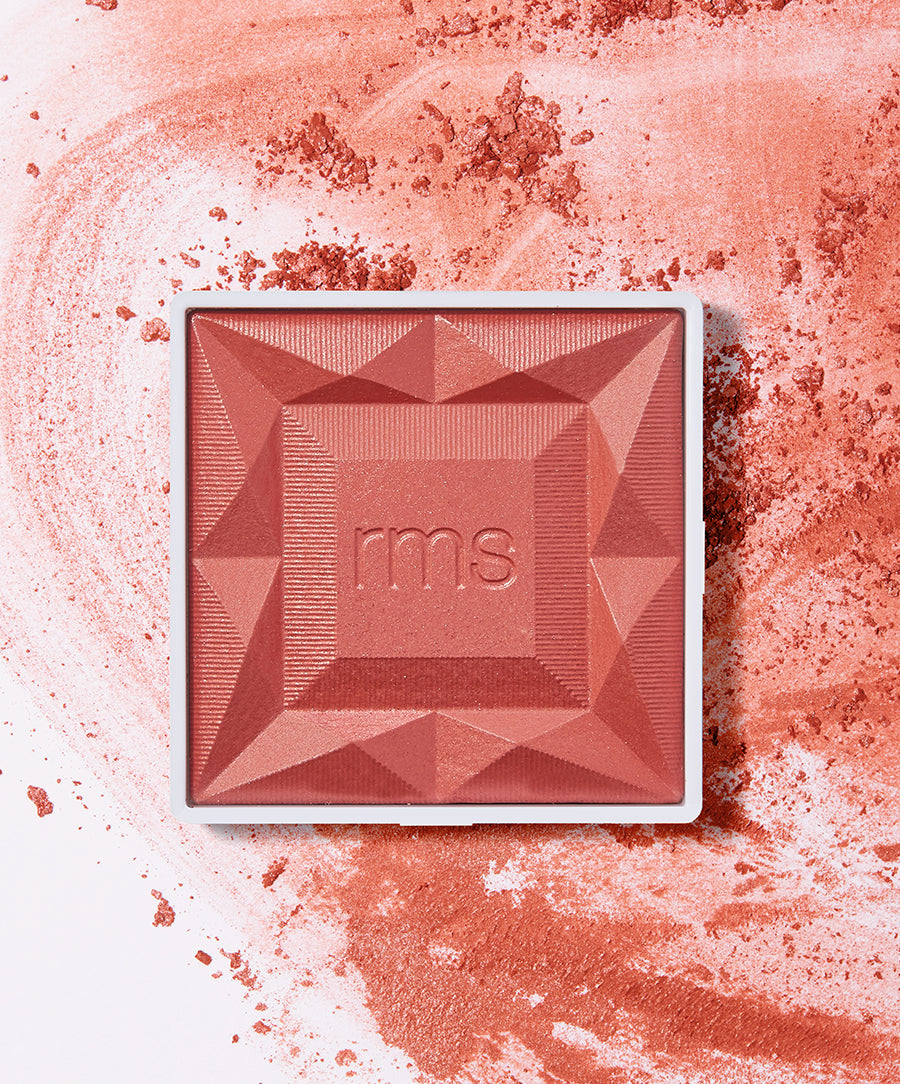 Close-up of ReDimension Hydra Powder Blush in a warm sangria shade with textured geometric design, showcasing clean beauty and sustainable packaging by RMS Beauty.