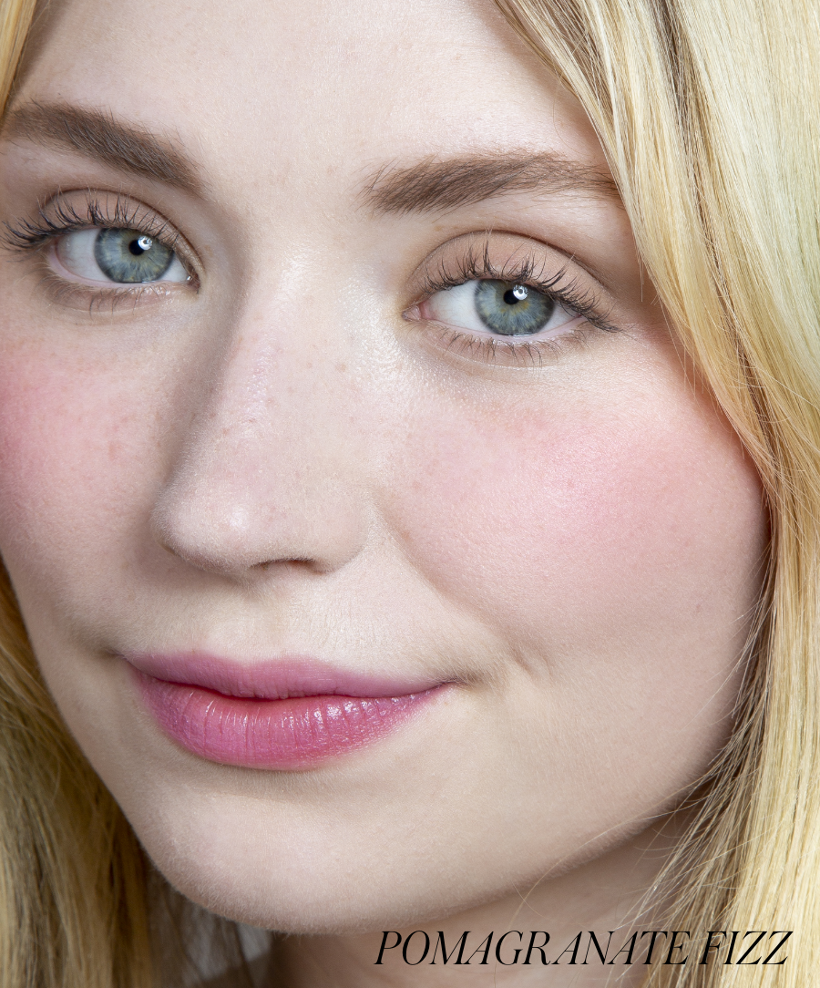 Close-up of a woman with clear skin wearing ReDimension Hydra Powder Blush in a soft pink shade, highlighting a natural, radiant look with clean beauty and cruelty free makeup.